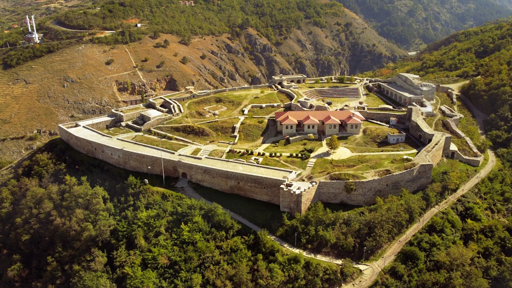 an aerial view of a castle in the mountains