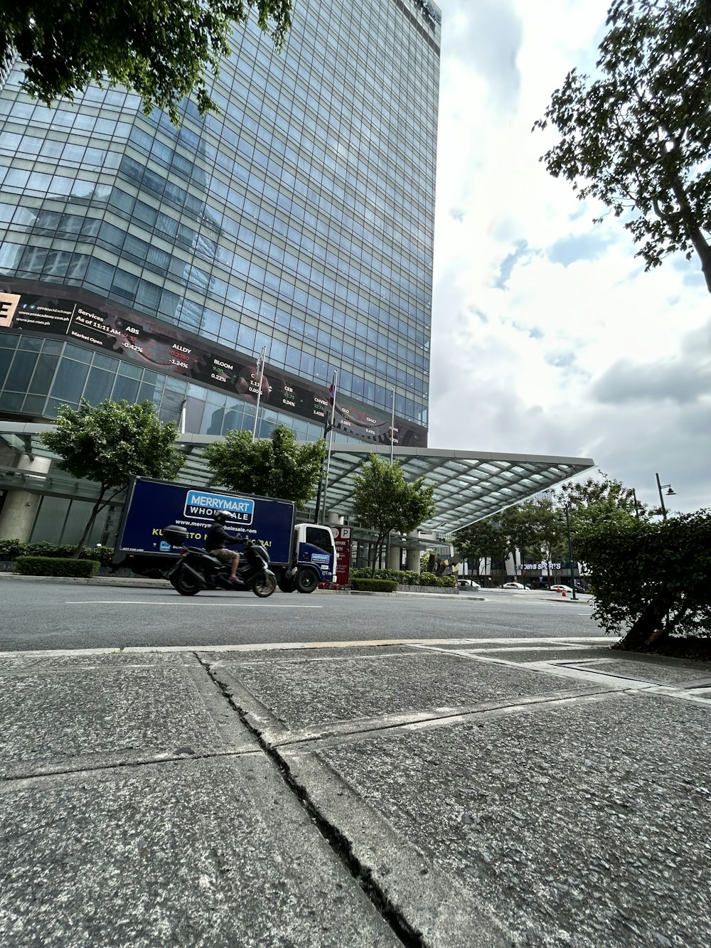 a city street with a large building in the background