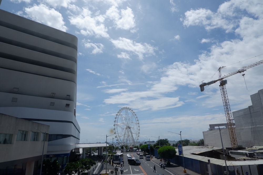 a view of a street with a ferris wheel in the background