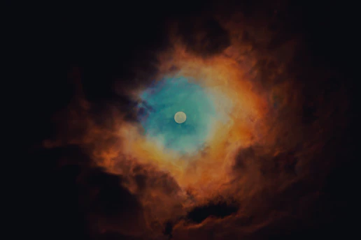 A vibrant celestial-themed illustration with stars and zodiac symbols swirling around a glowing moon.