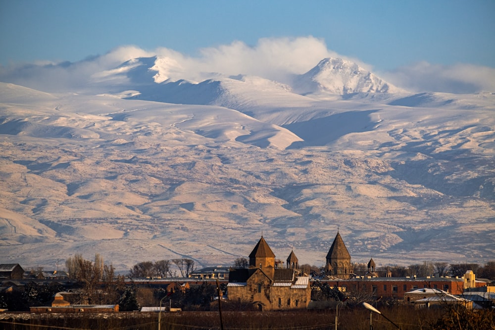 a view of a mountain range with a church in the foreground