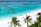 Couple relaxing on a tropical beach with palm trees and turquoise water