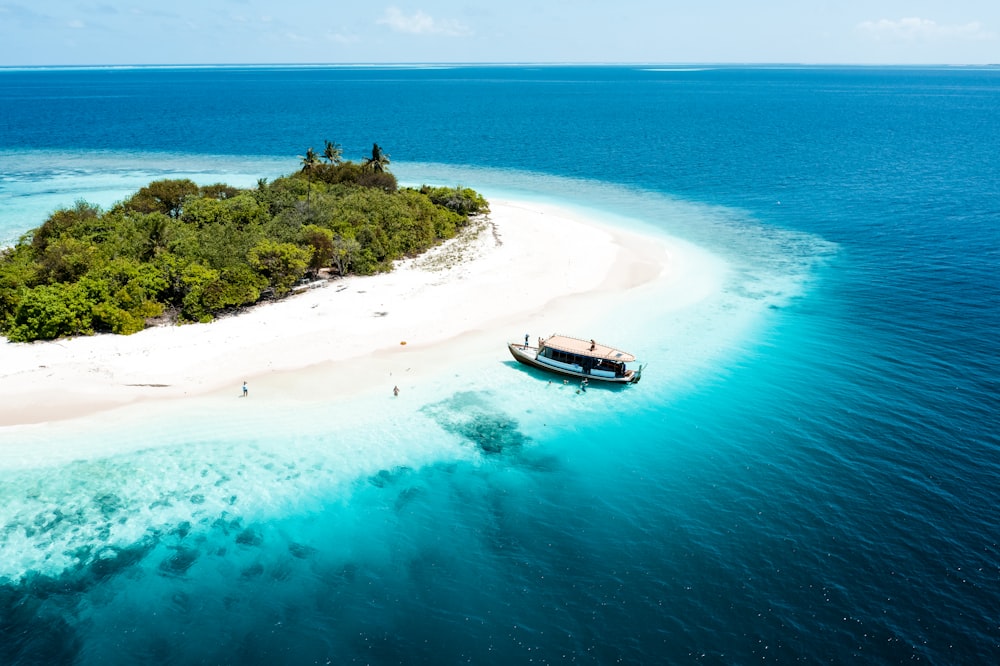 an island with a boat on it in the middle of the ocean