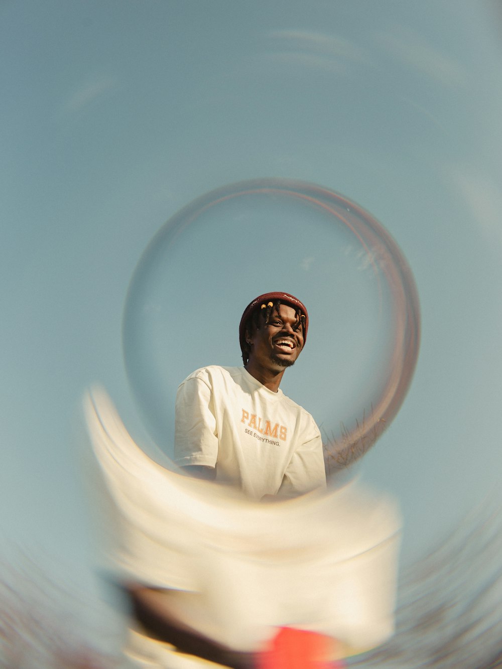 a man in a white shirt is holding a frisbee