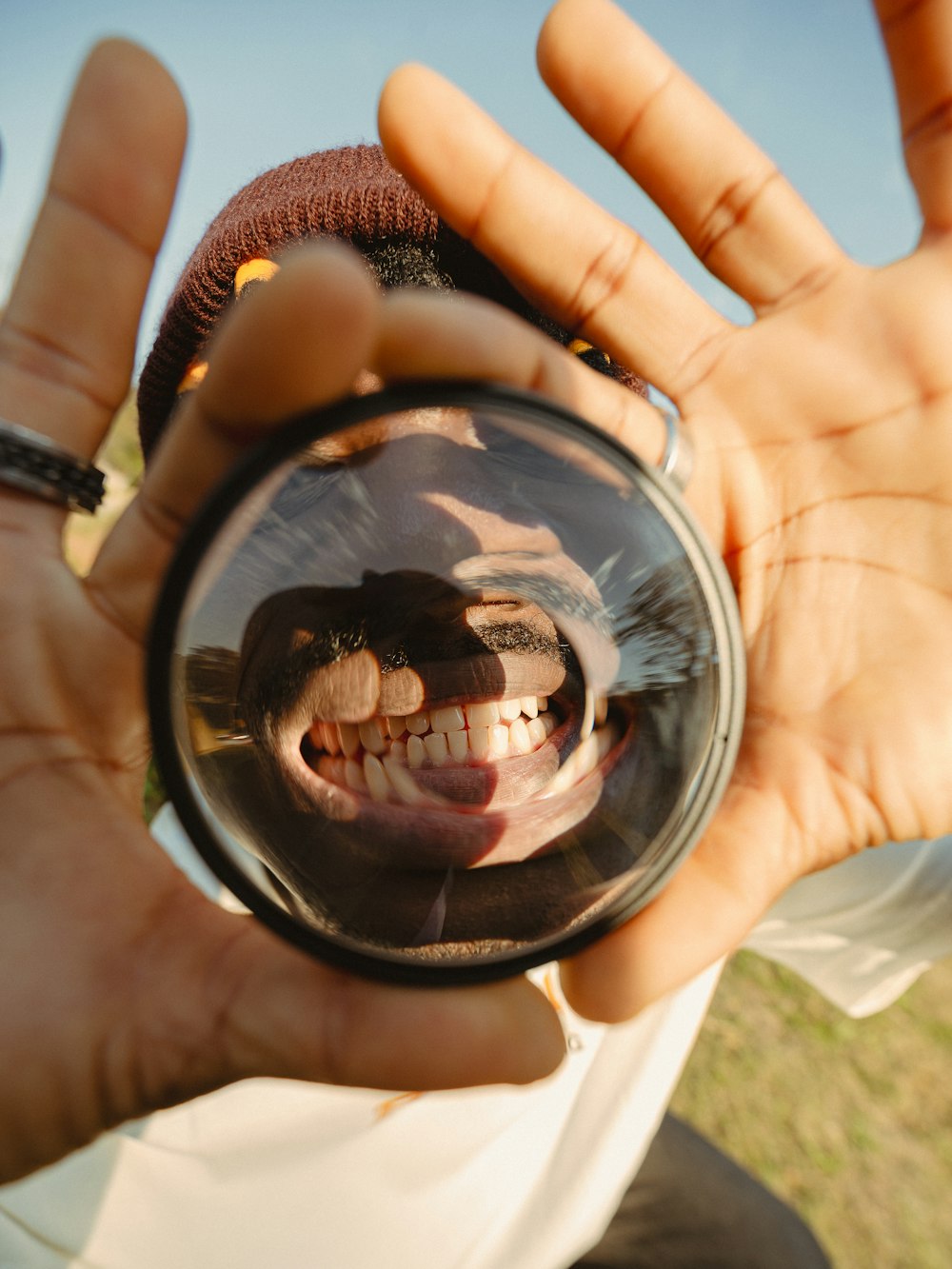a person holding a mirror with a smiling face on it