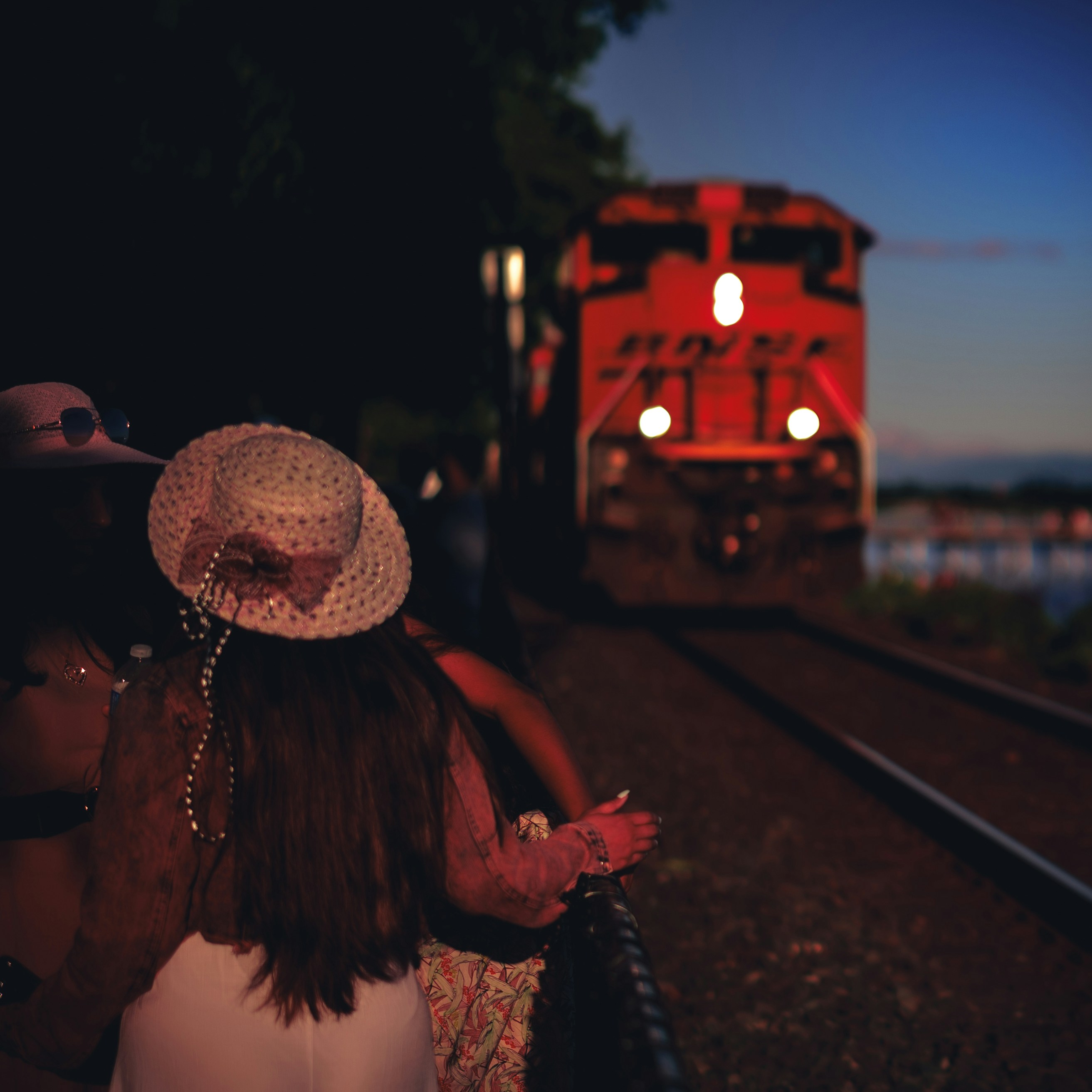 a group of people watching a train go by