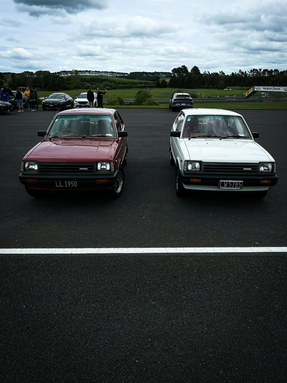 a couple of cars parked next to each other in a parking lot