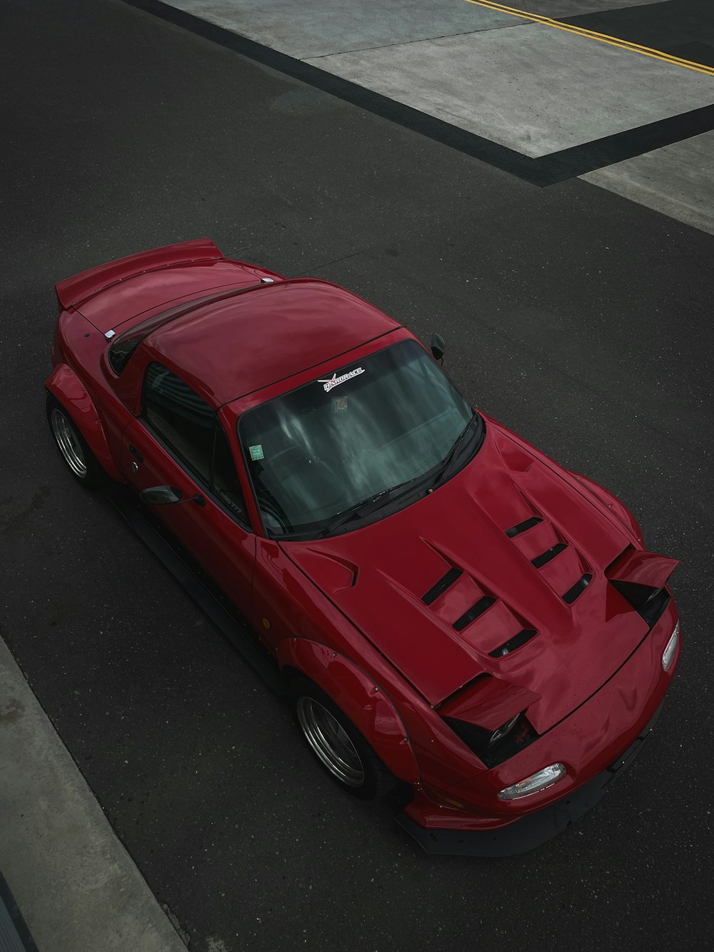 a red sports car parked in a parking lot