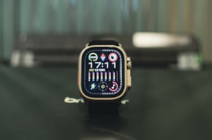 A modern smartwatch displaying notifications, set on a reflective blue table.
