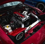 a red sports car with its hood open