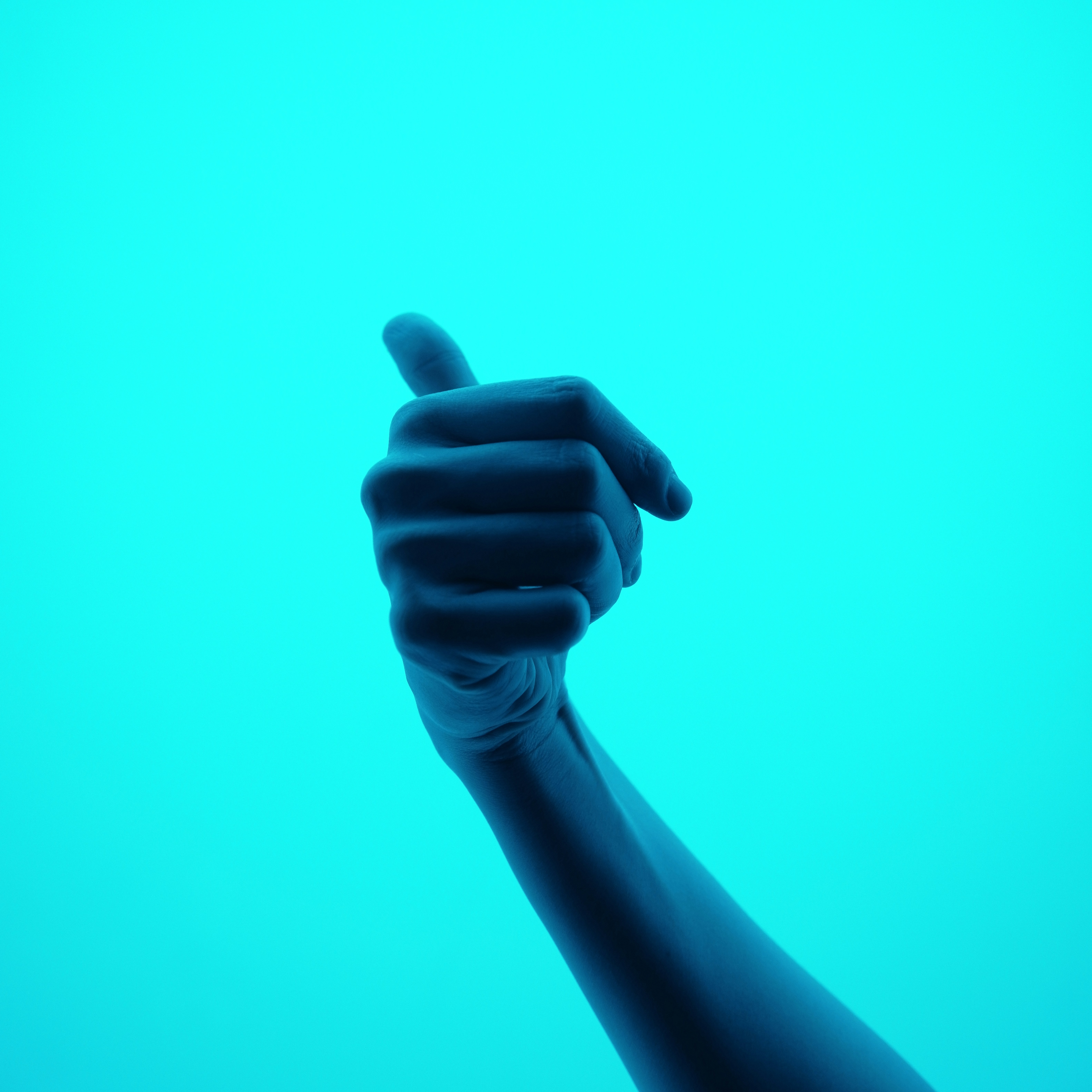 eine Hand, die ein Handy in die Luft hält