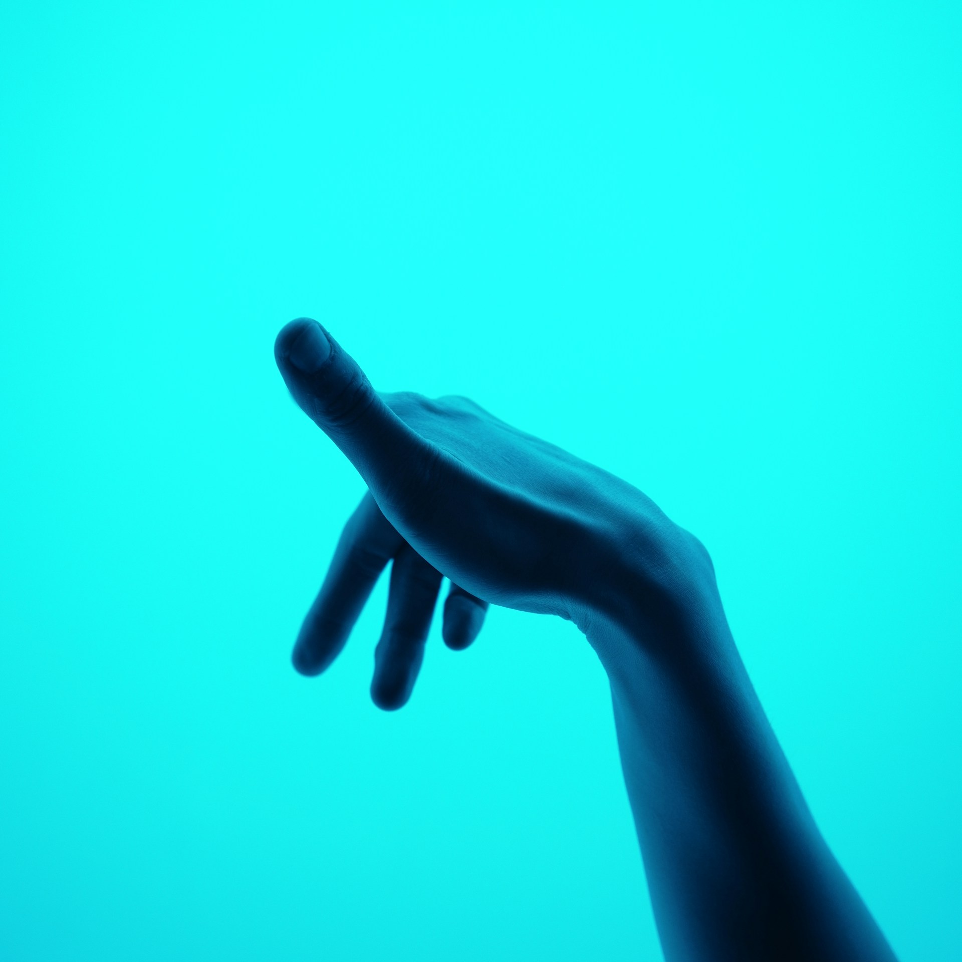 a hand reaching for something in the air