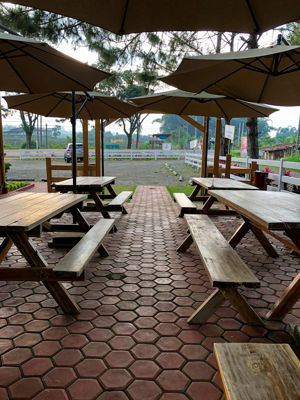 a picnic area with picnic tables and umbrellas