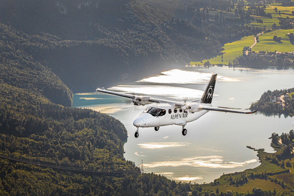 a small plane flying over a large body of water