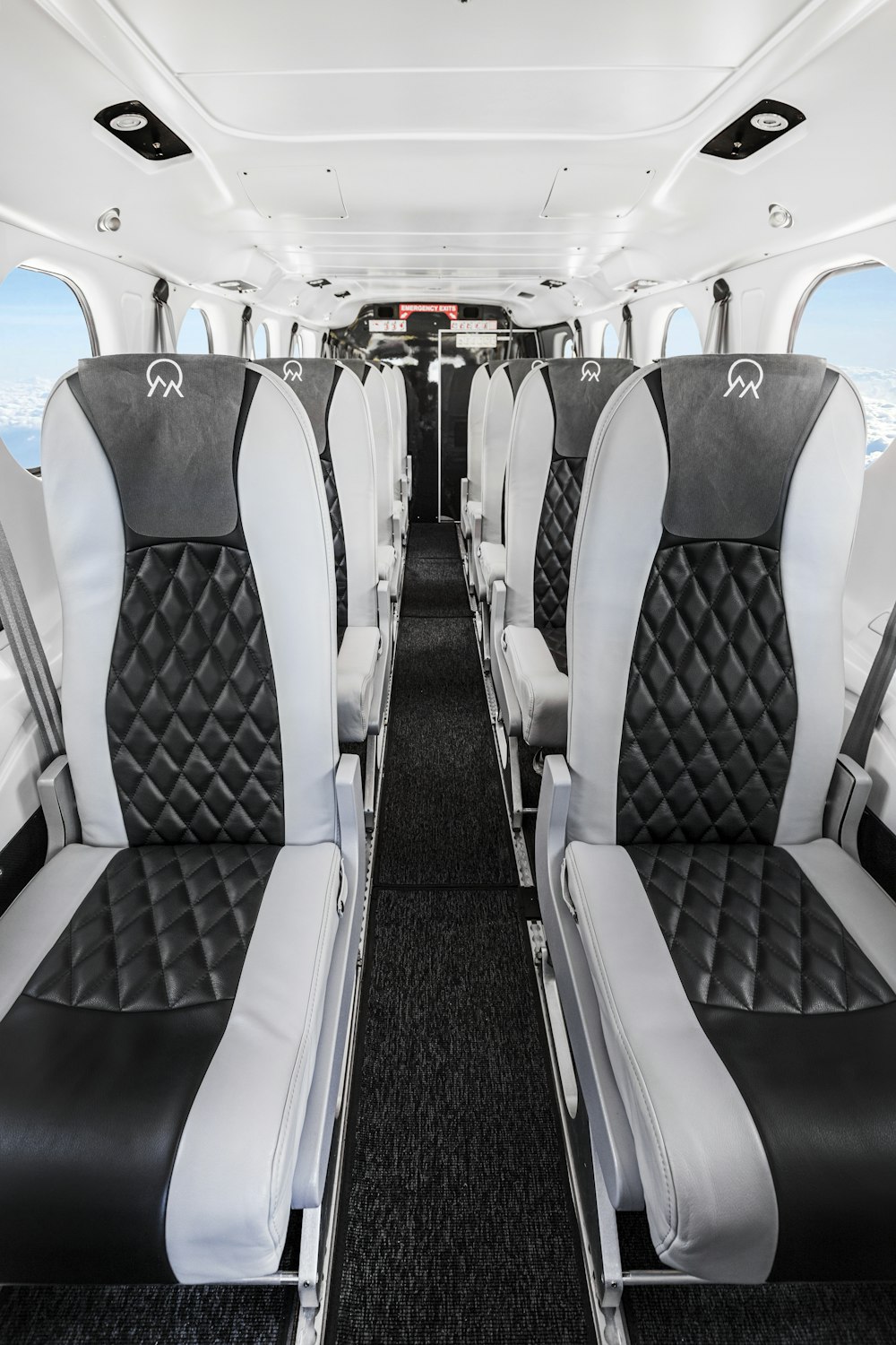 the interior of an airplane with black and white seats