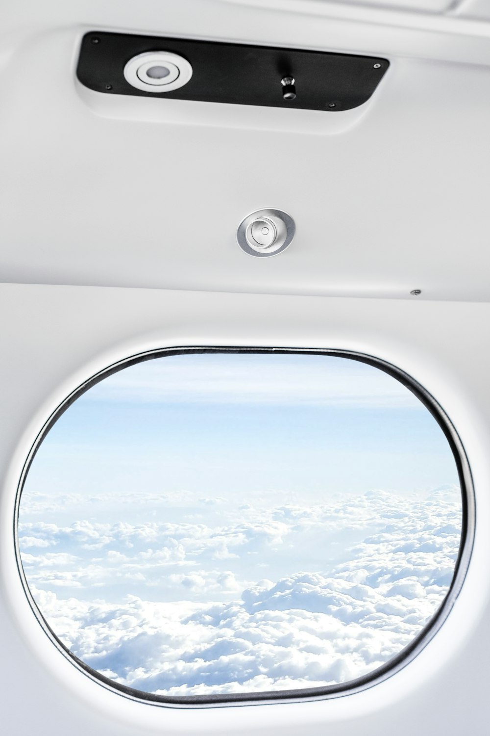 an airplane window with a view of the clouds