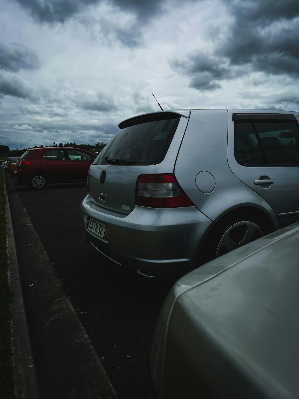 a silver car parked on the side of a road