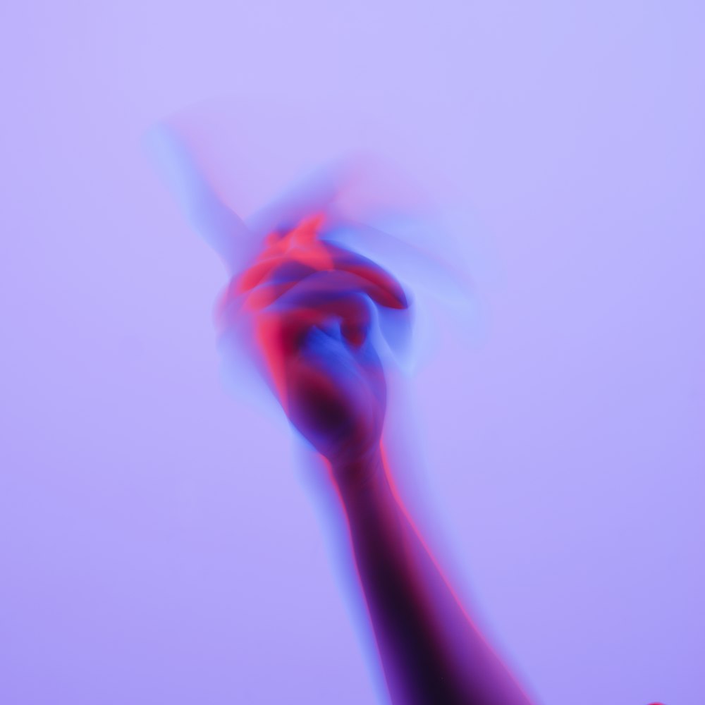 a blurry image of a hand holding a toothbrush