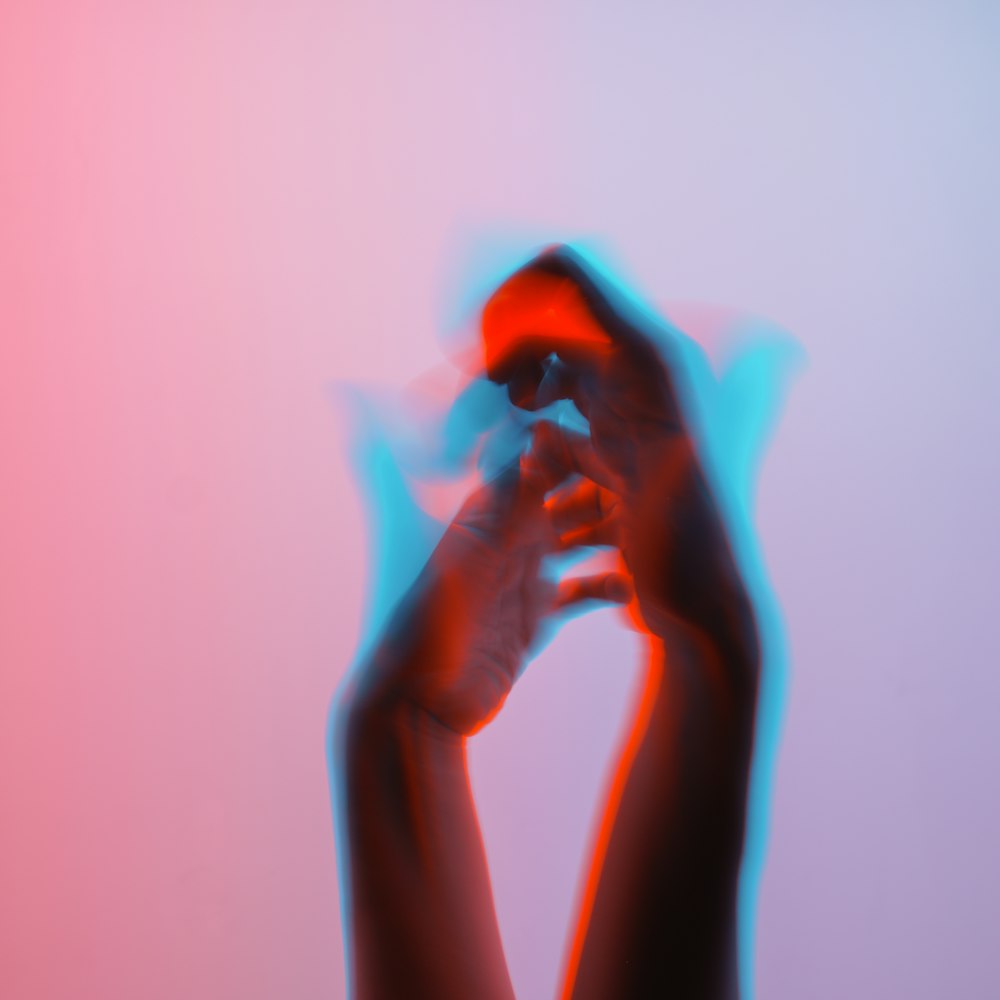 a blurry image of a person's hands holding something