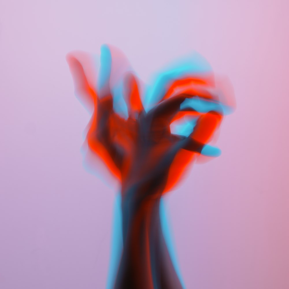 a blurry image of a hand holding something