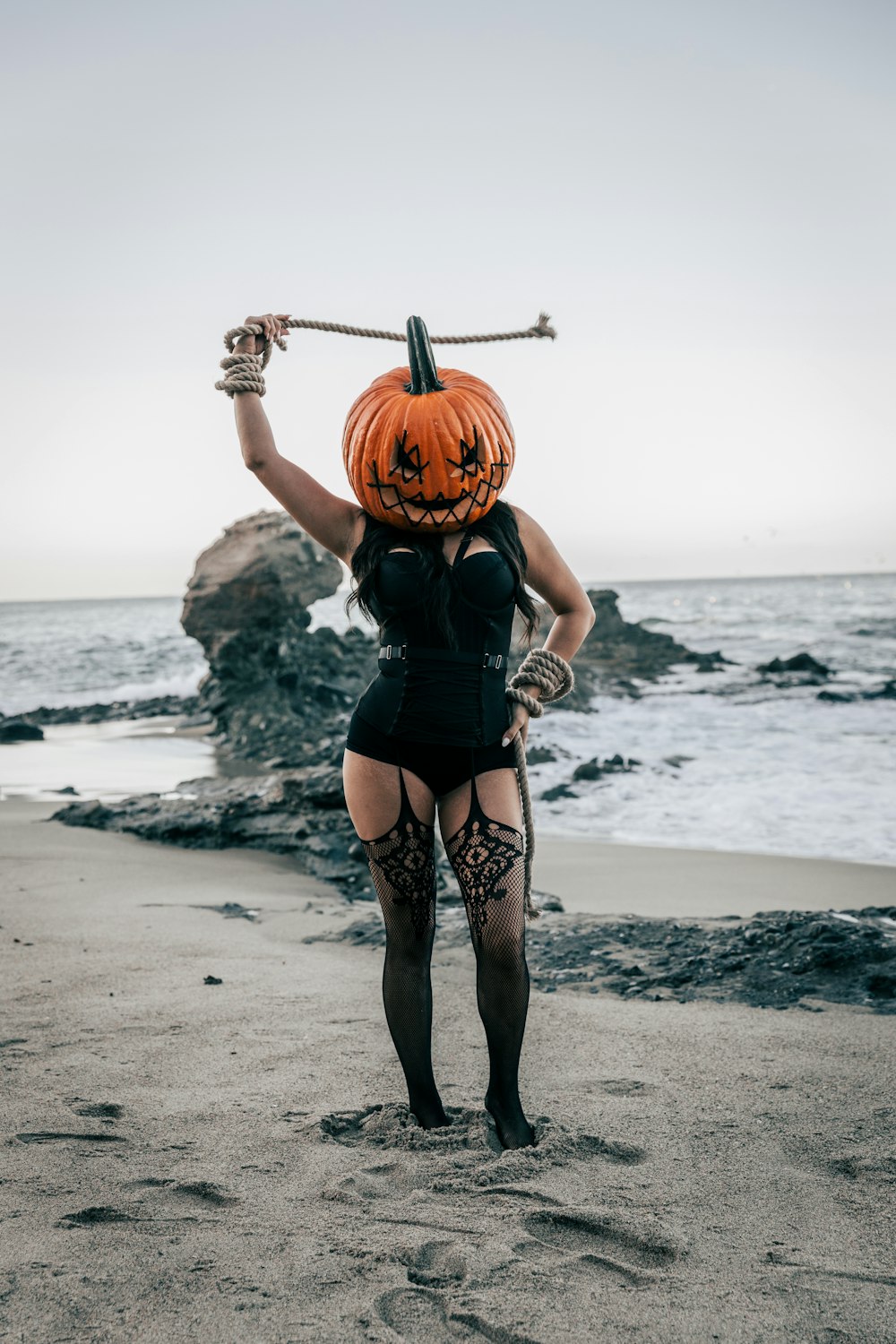 a woman with a pumpkin on her head