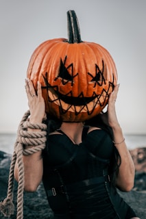 a woman with a pumpkin on her head