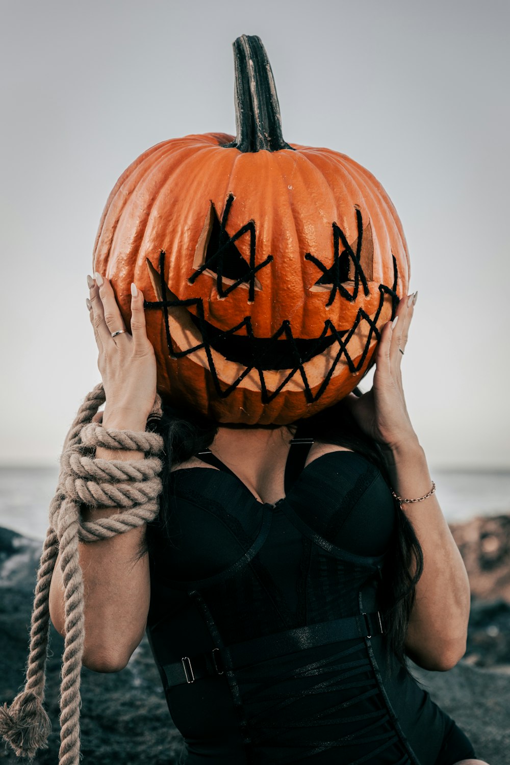 a woman with a pumpkin on her head