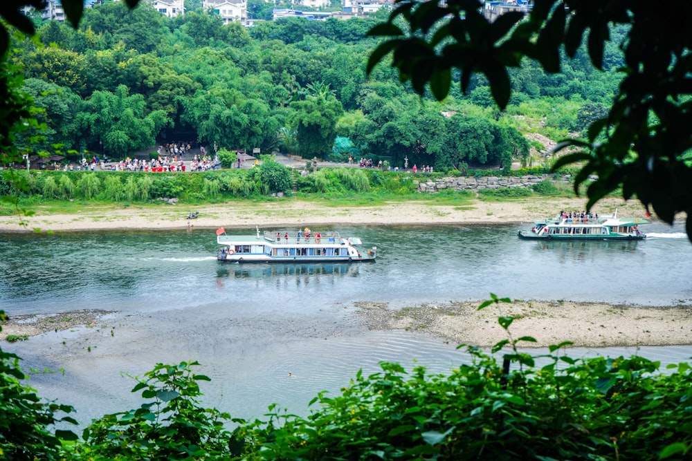 a couple of boats floating on top of a river