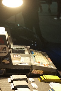 A cozy desk scene with vibrant trading cards, game boxes, and a laptop showing an online store.