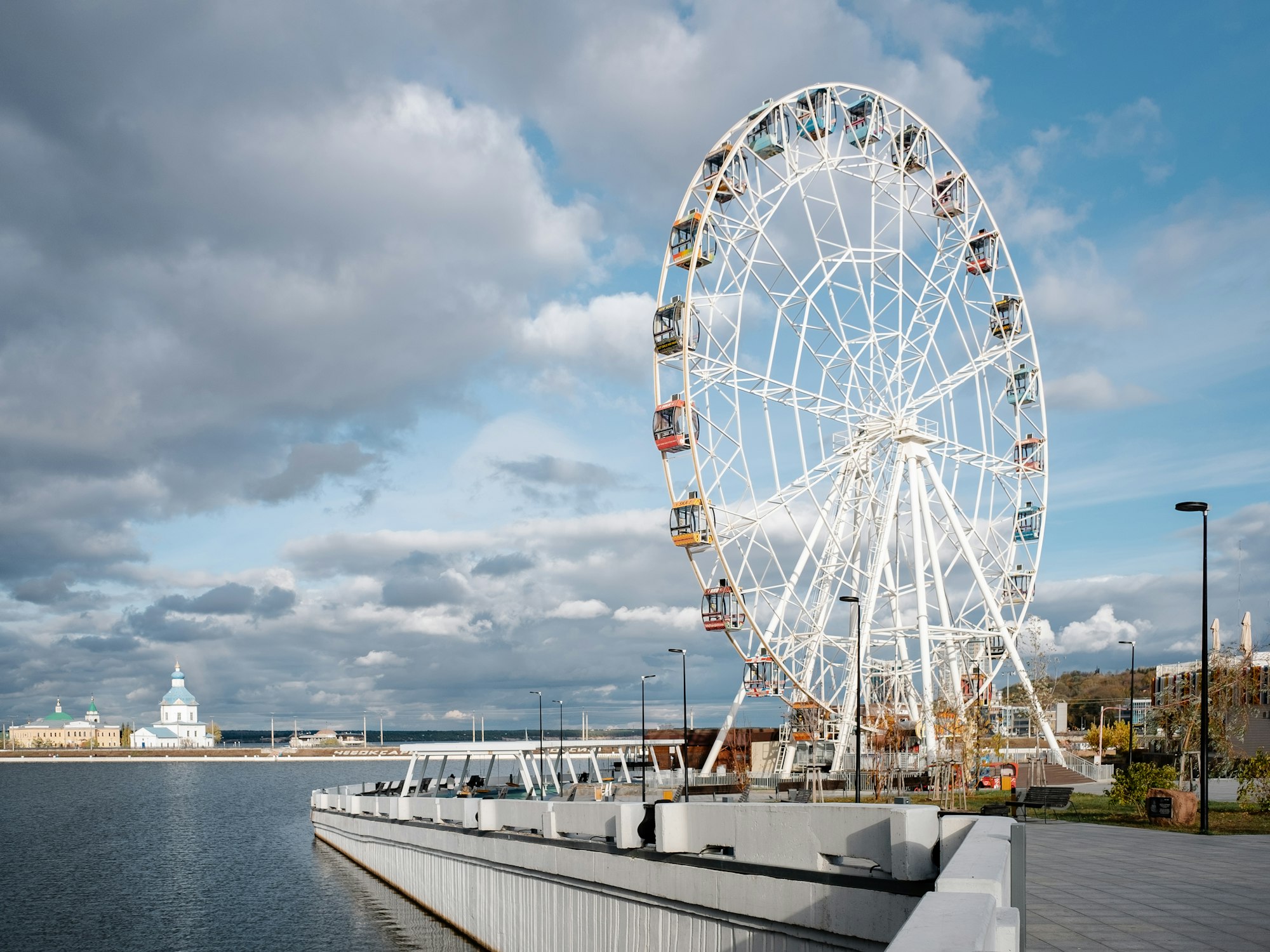 a large ferris wheel sitting next to a body of water