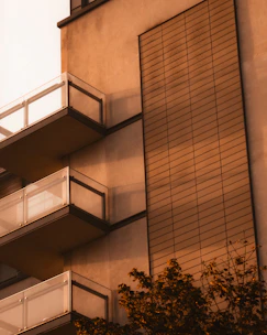 A modern residential building in Michigan bathed in warm evening light.