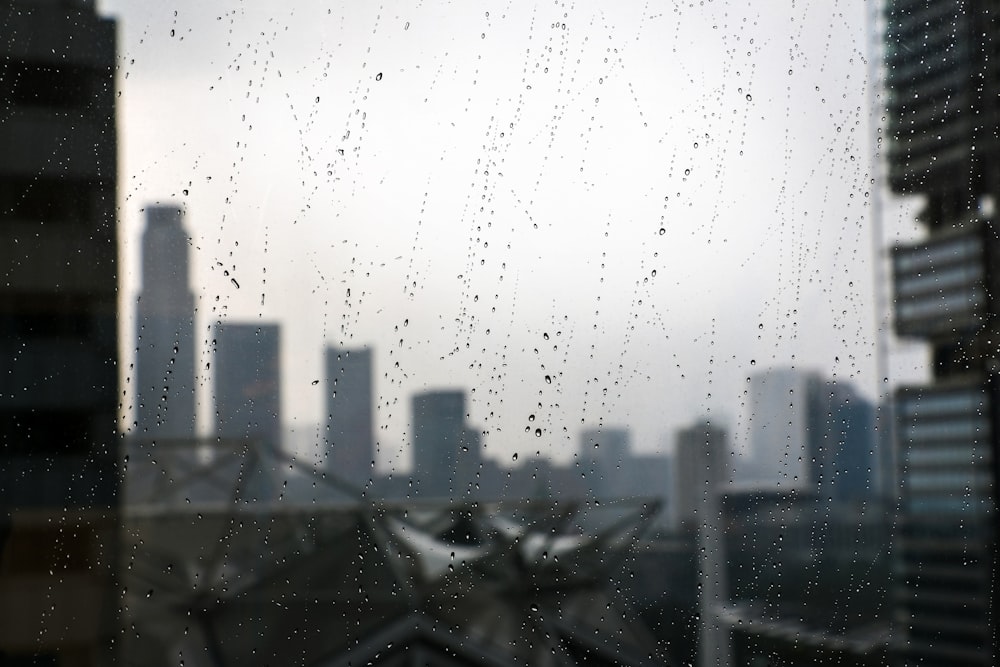 a view of a city through a rainy window