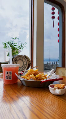 Colorful kids' fast food items arranged on a clean table at a playful indoor park setting.
