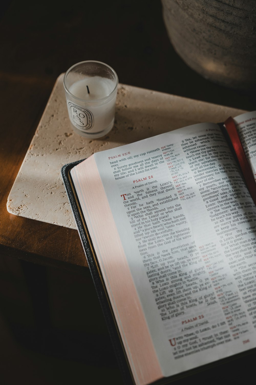 a candle and a book on a table