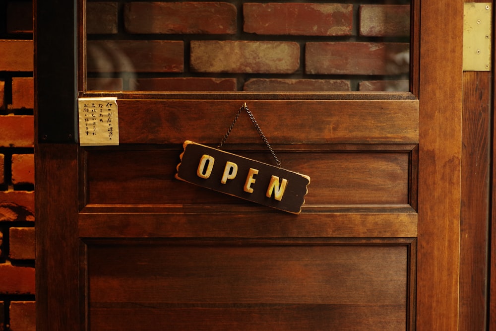 a sign that reads open hanging on a door