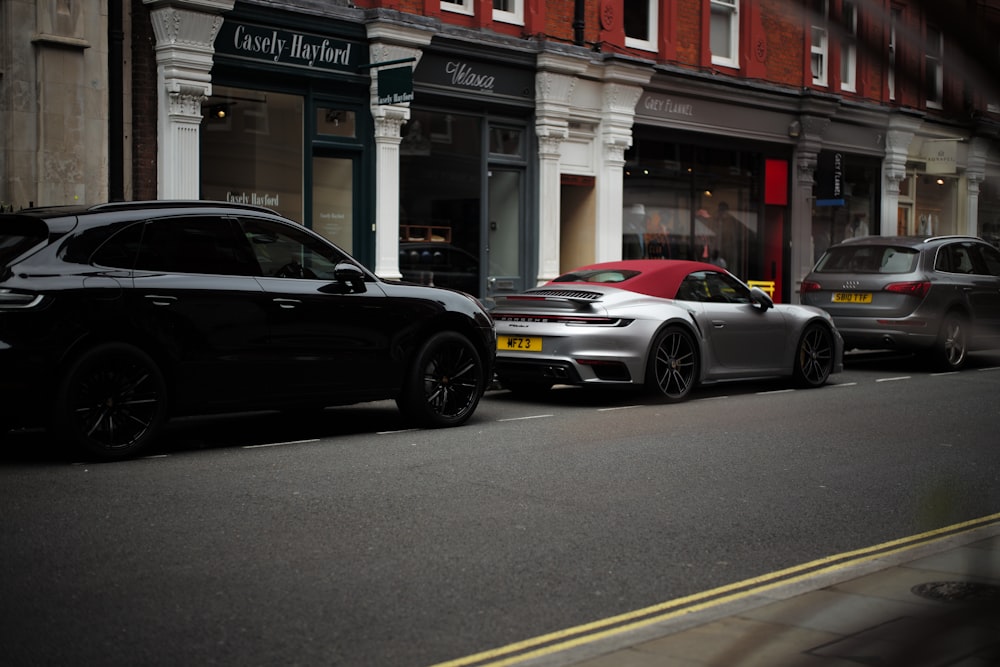 a couple of cars parked on the side of a street