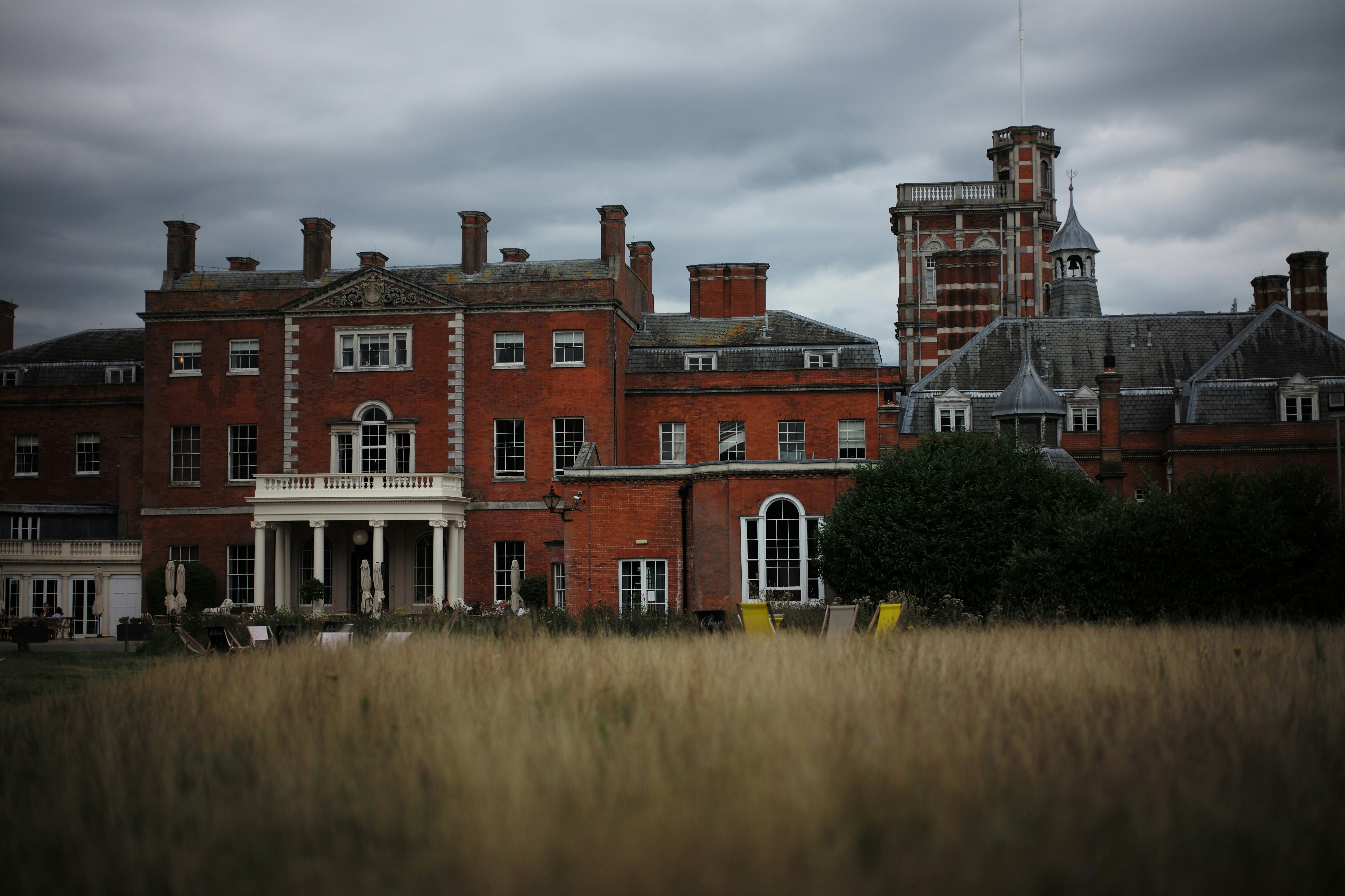 a large red brick building with a clock tower