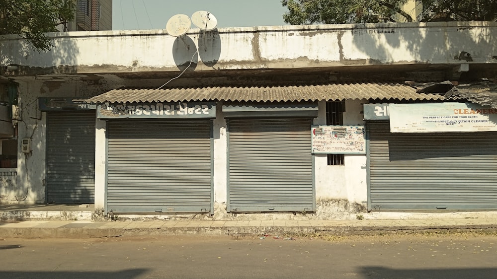 a run down building with shutters on the front