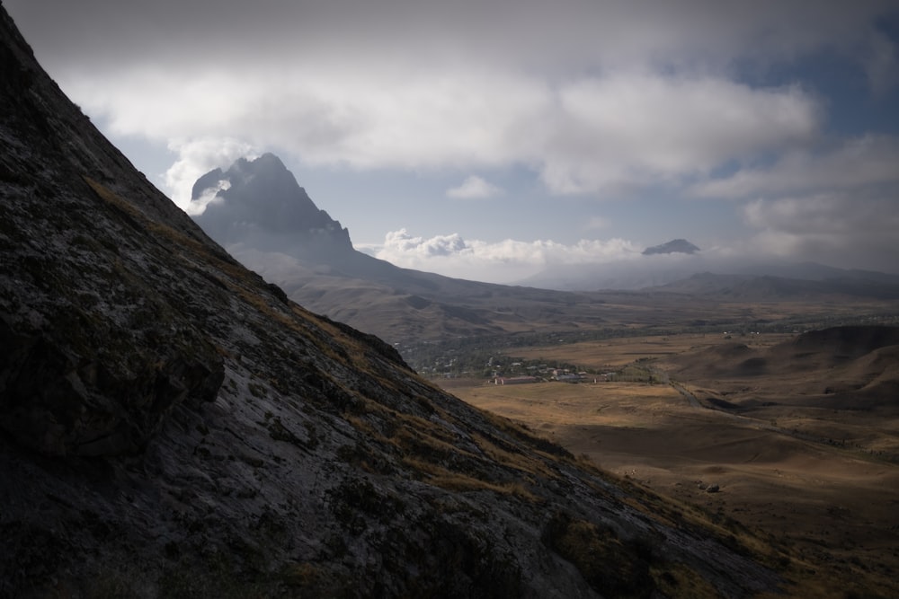 a view of a mountain range with clouds in the sky