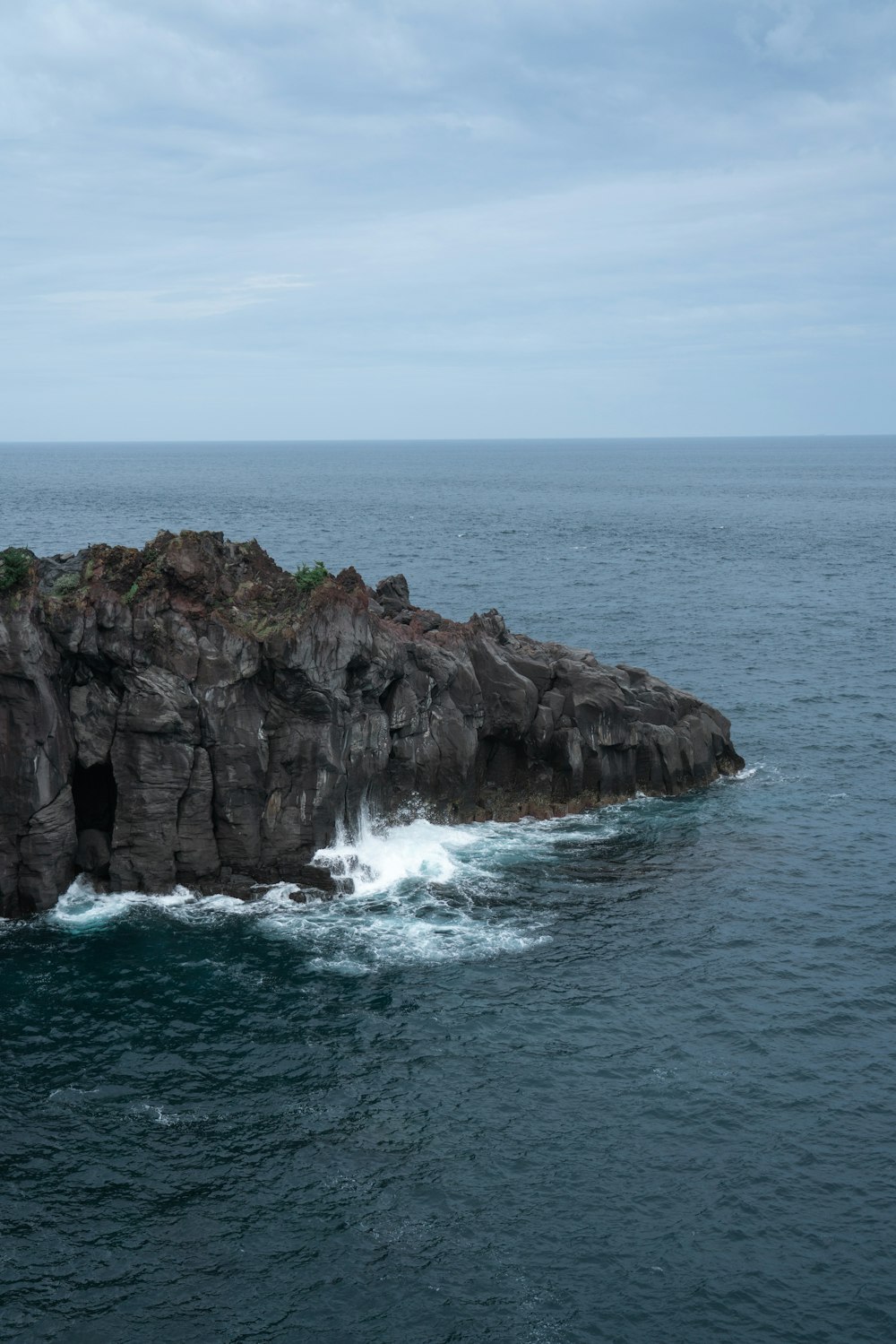 a rock outcropping in the middle of the ocean