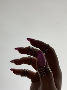 a woman's hand with rings on it