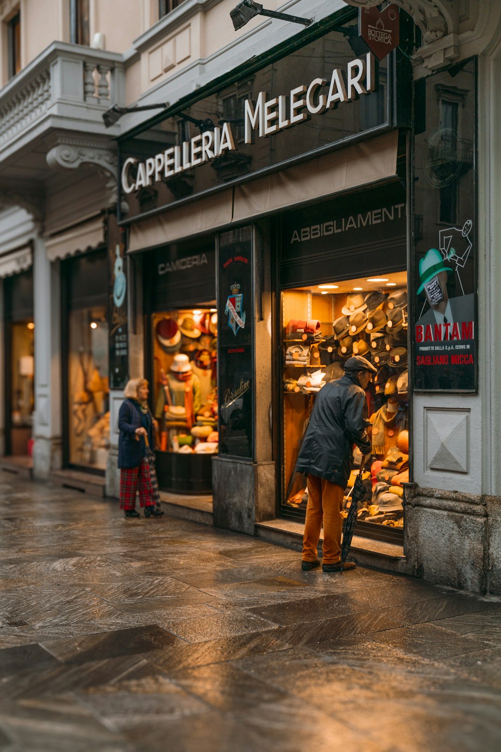 a man standing in front of a store window