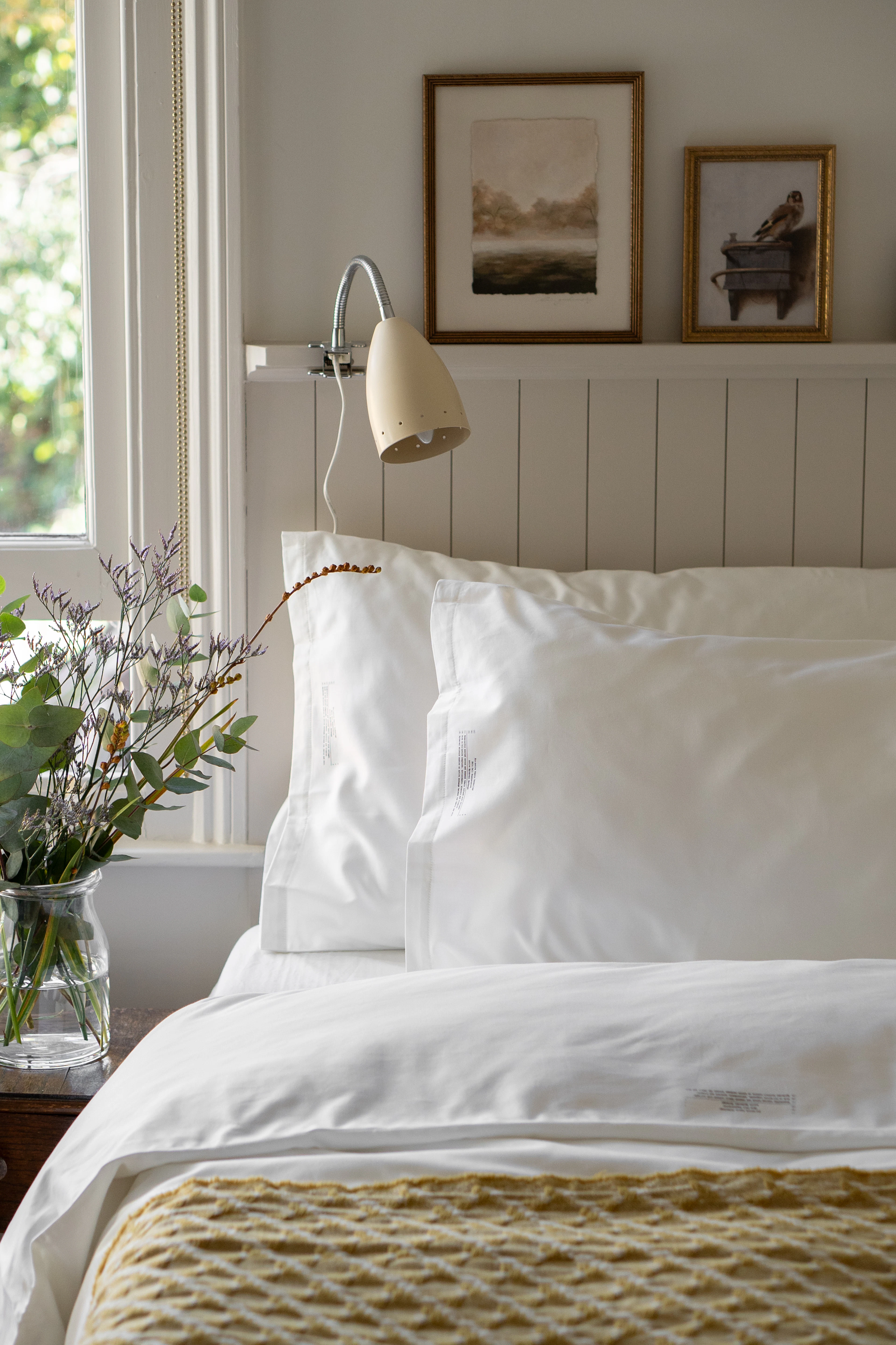 White linen quilt cover in a bright bedroom
