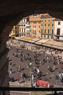 Photo of a lively city square filled with people and colorful buildings.