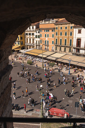 A vibrant painting of Vernier's old town square bustling with people during a sunny day.