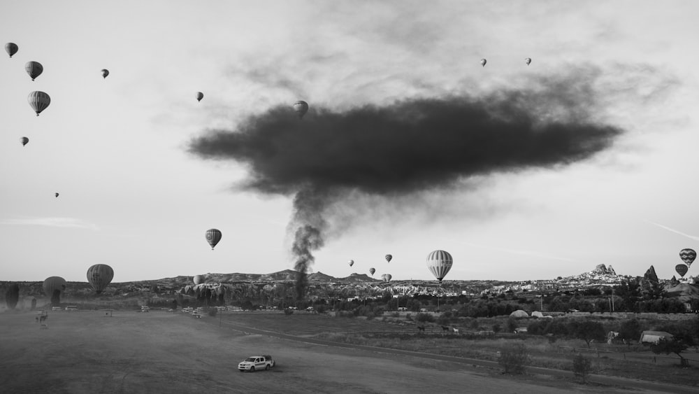 a lot of hot air balloons flying in the sky