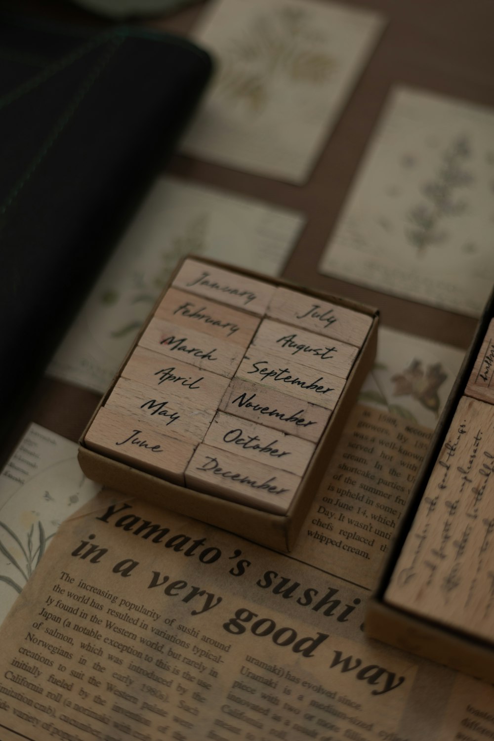 a couple of wooden blocks sitting on top of a newspaper