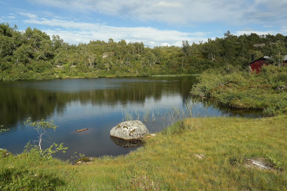 a large rock sitting in the middle of a lake