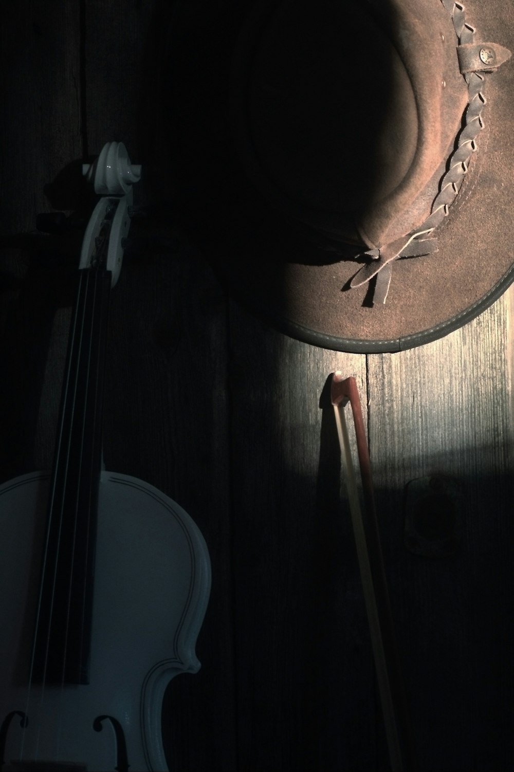 a hat and a violin on a table