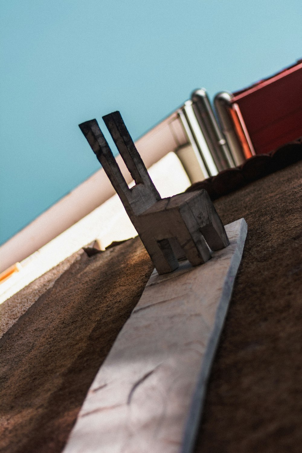 a pair of scissors sitting on top of a piece of concrete